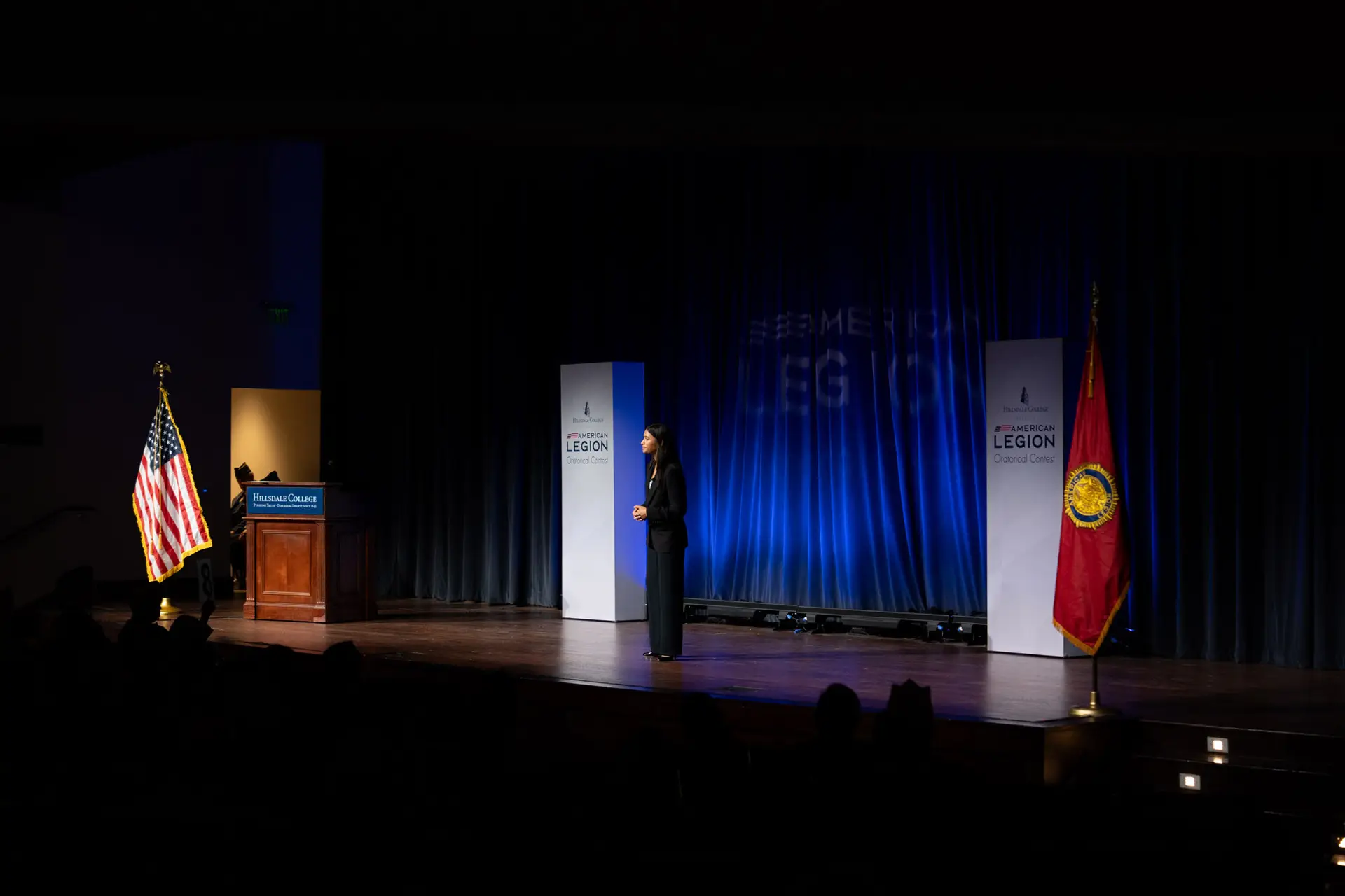 A contestant speaking on stage at the 2025 National Oratorical Contest Finals at Hillsdale College.