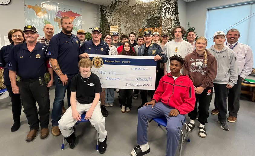 Post 3 members and Military Pathways students gather with a contribution.